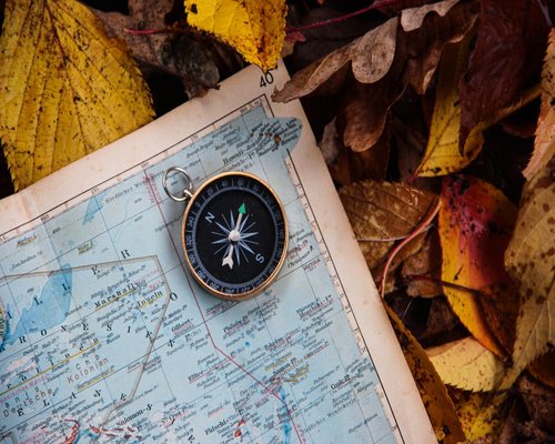 A detailed map with a compass placed on top